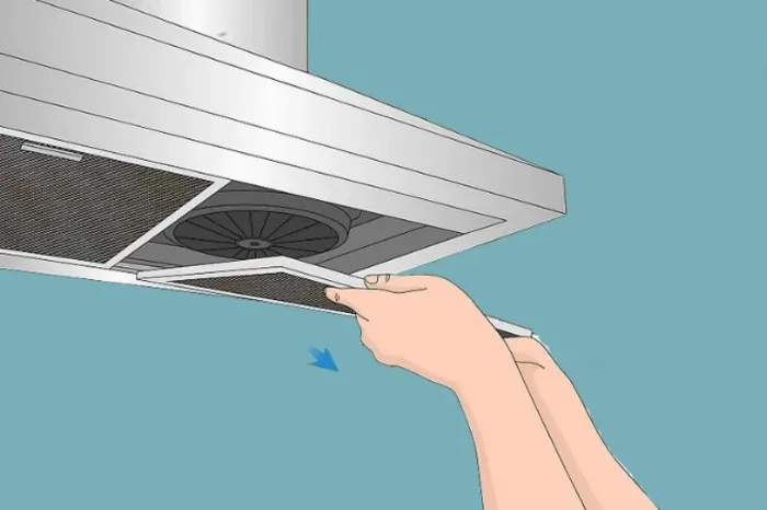 Tháo lưới lọc máy hút mùi bằng cách ấn nhẹ lẫy cài